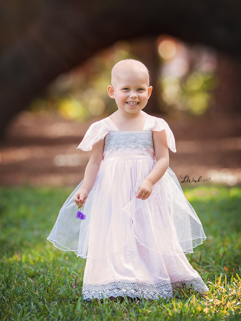 little girl in silver and pink tulle princess dress chemotherapy bald head