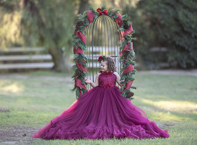 Girl sitting in chair with holiday garland