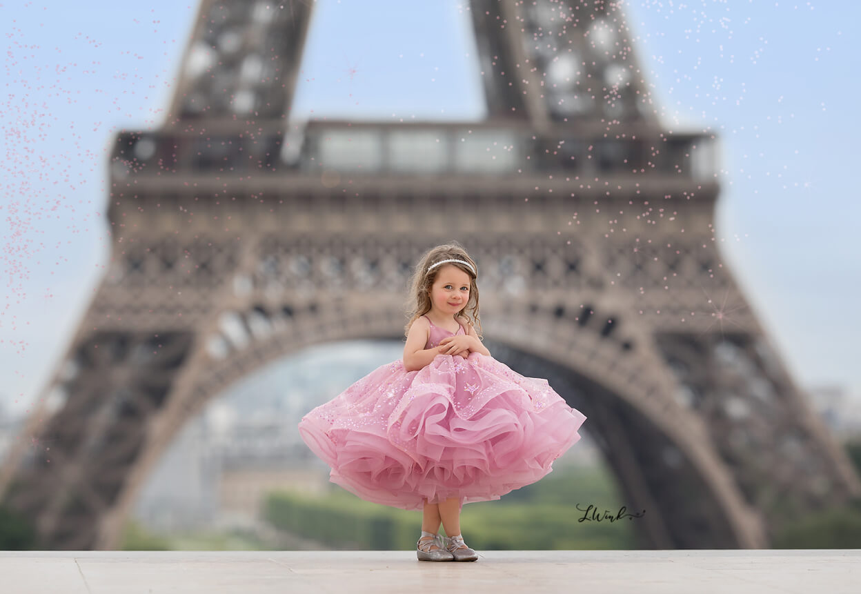 Toddler in pin dress at Eiffel Tower, Paris
