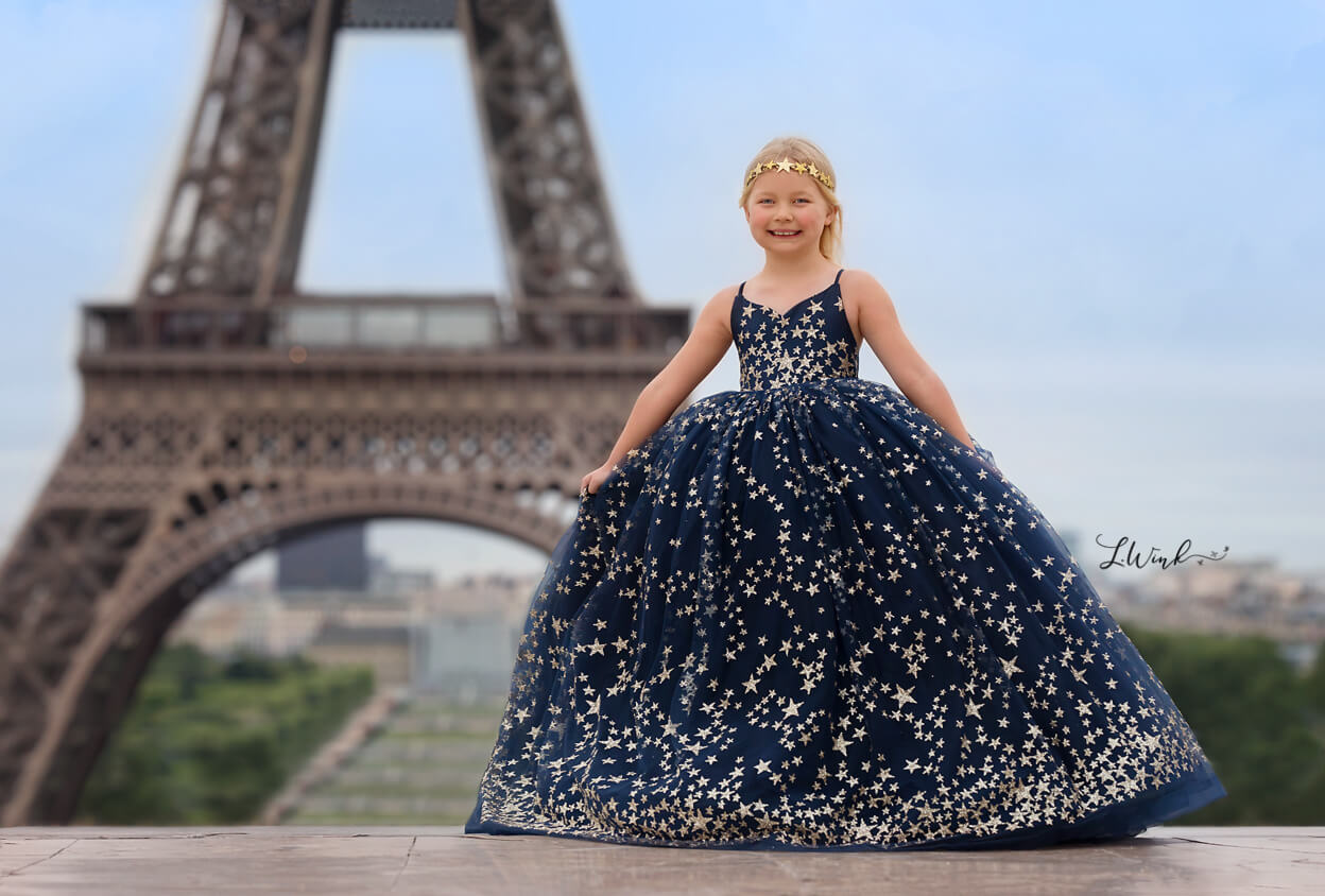 Girl in blue star dress at Eiffel Tower