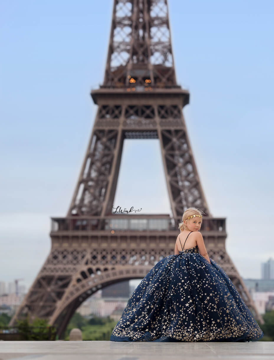 girl in blue star dress at Eiffel Tower