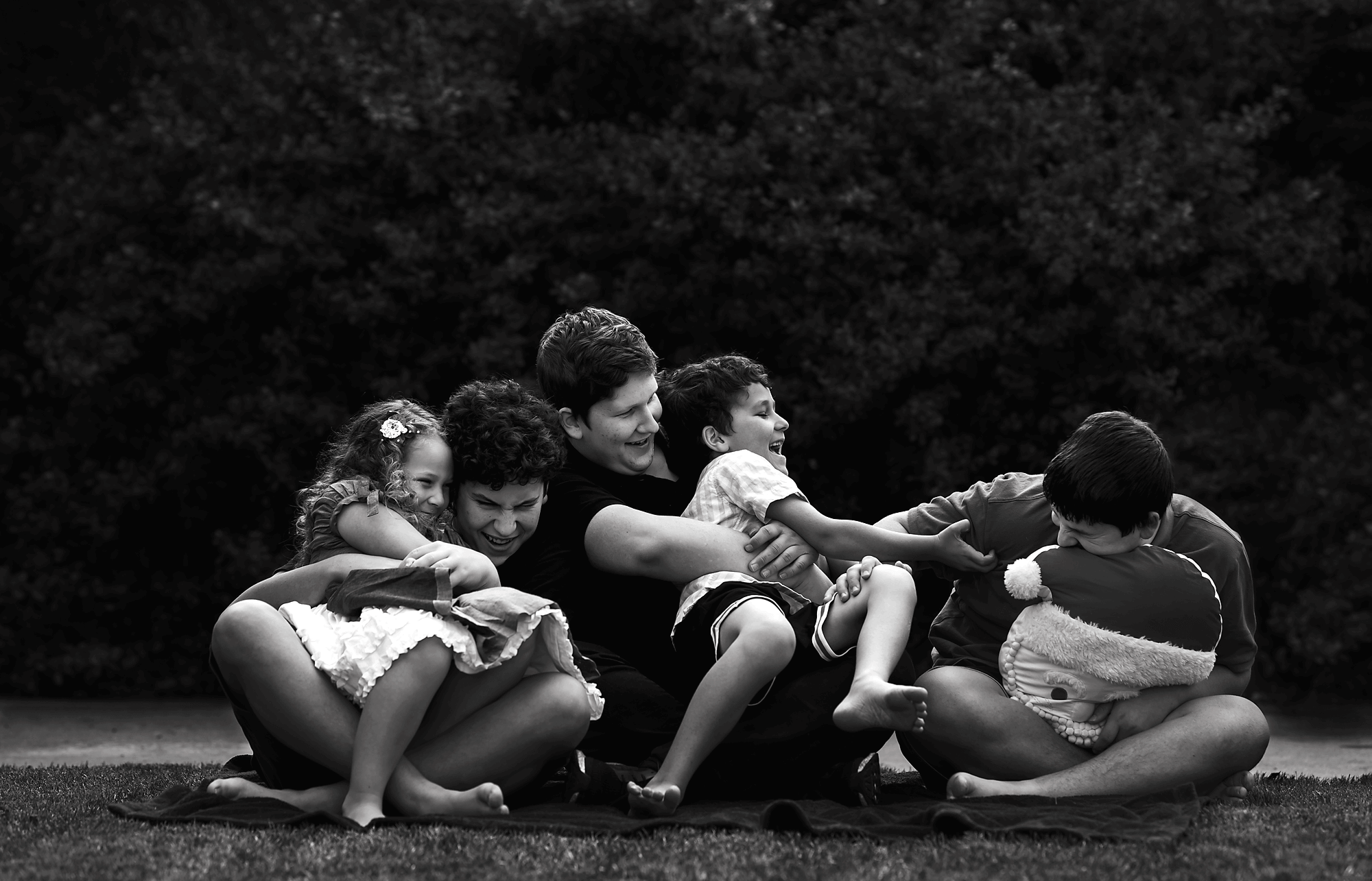 Four kids tickling in black and white