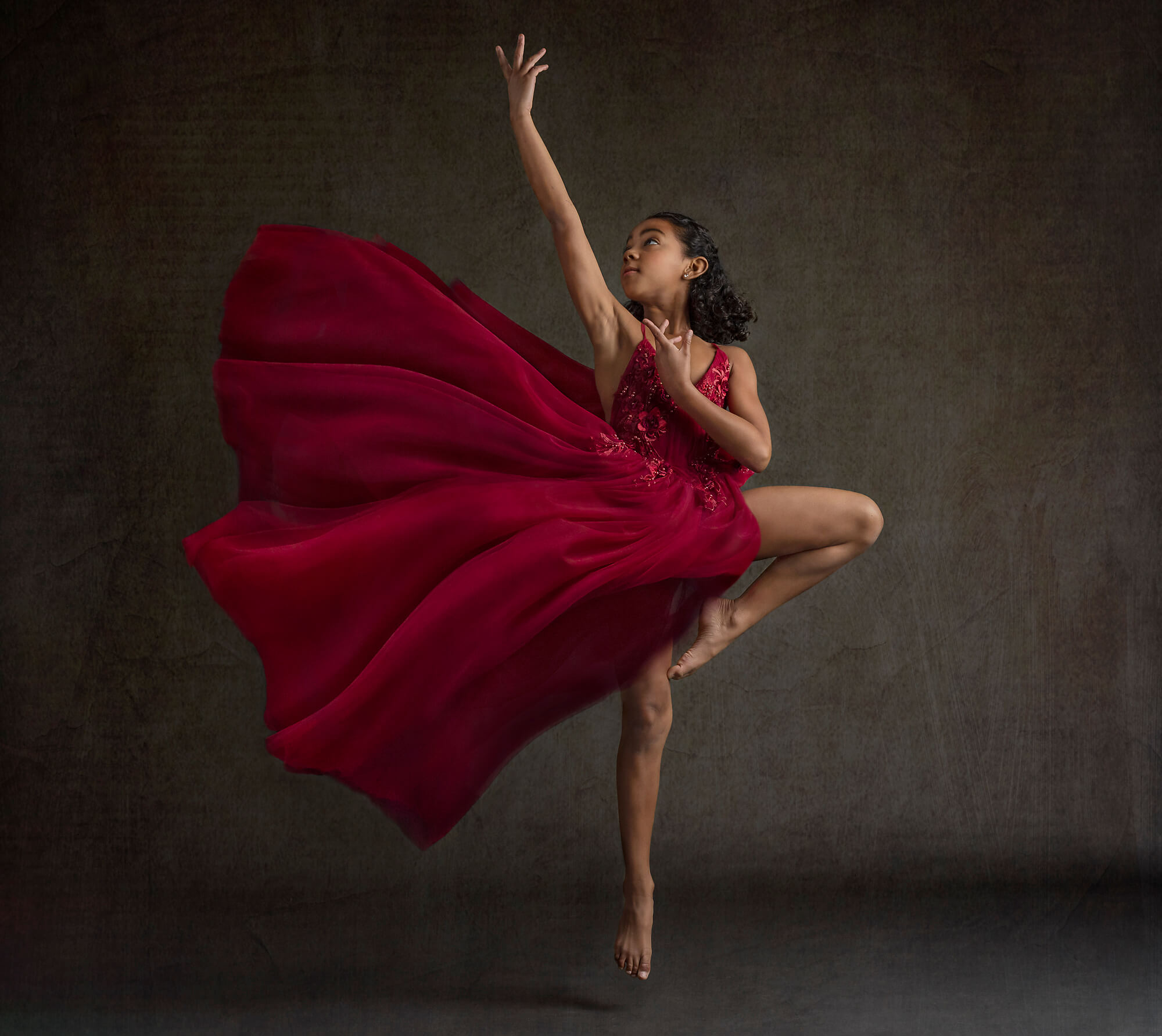 Dancer in red dress reaching up in Redondo Beach photography studio