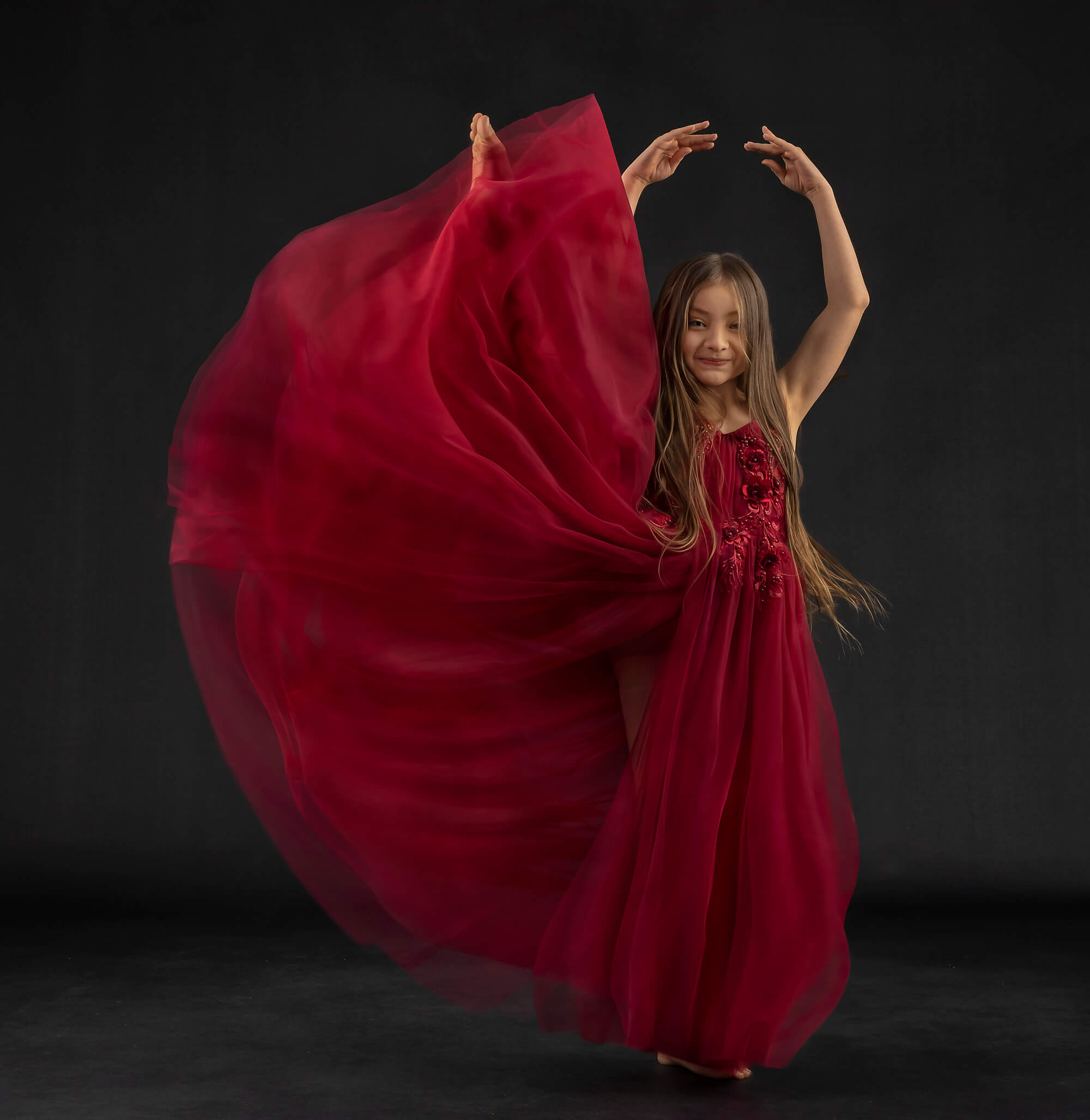 Fine art dancer girl in a red dress