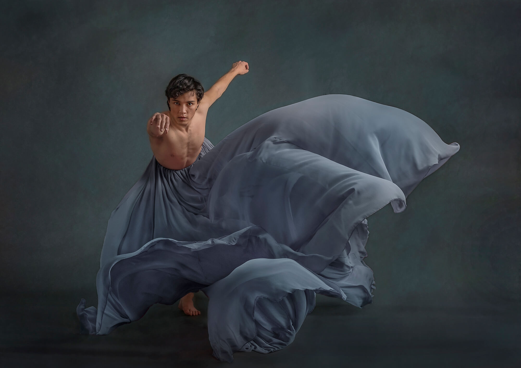 Dancer in art studio wearing a large flowing skirt