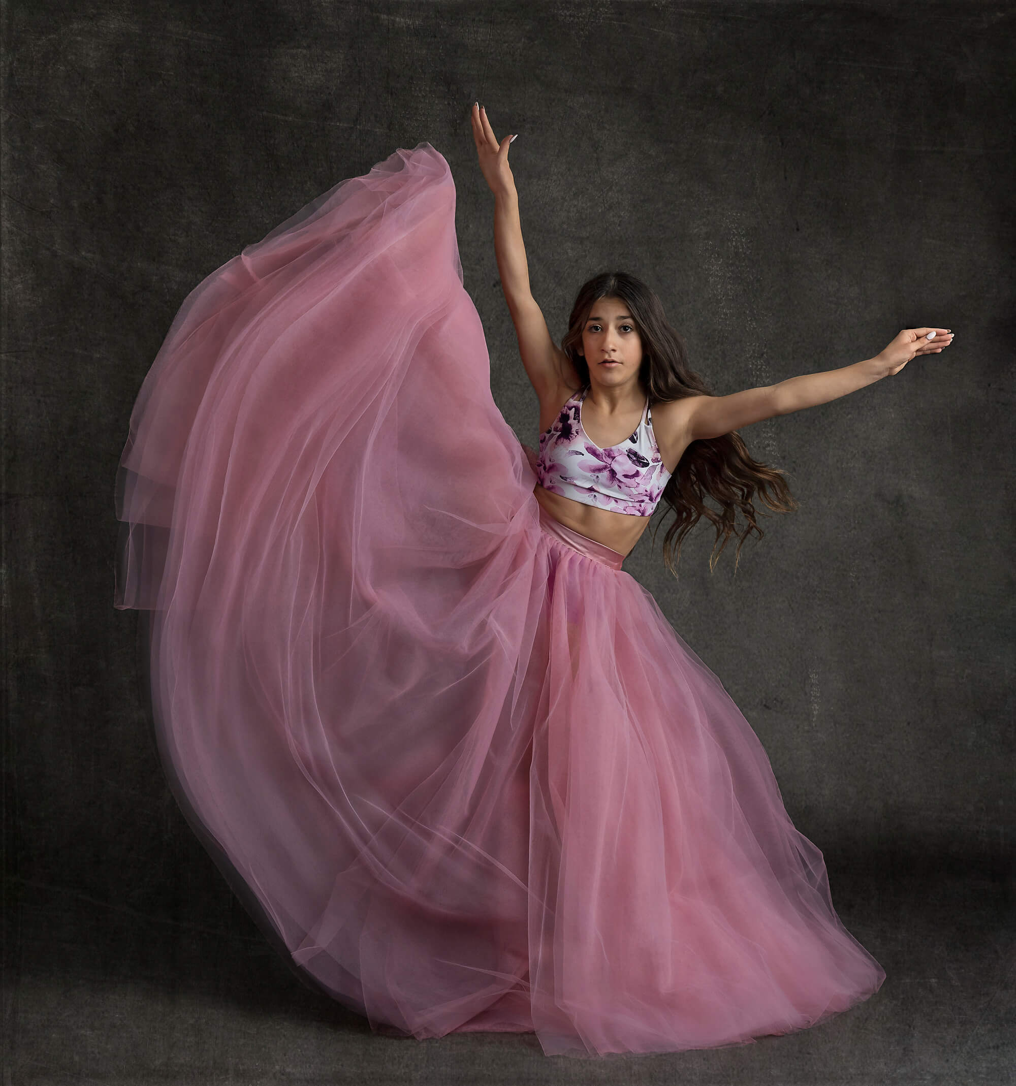 Ballerina kicking up leg in pink skirt